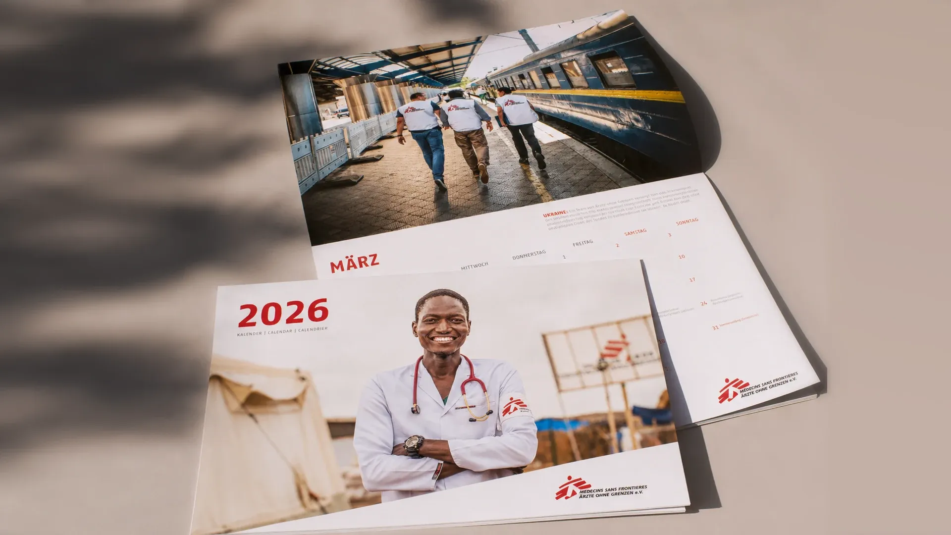 Kalender 2026 von Ärzte ohne Grenzen mit Titelblatt eines lächelnden Arztes und dem Monatsblatt März.